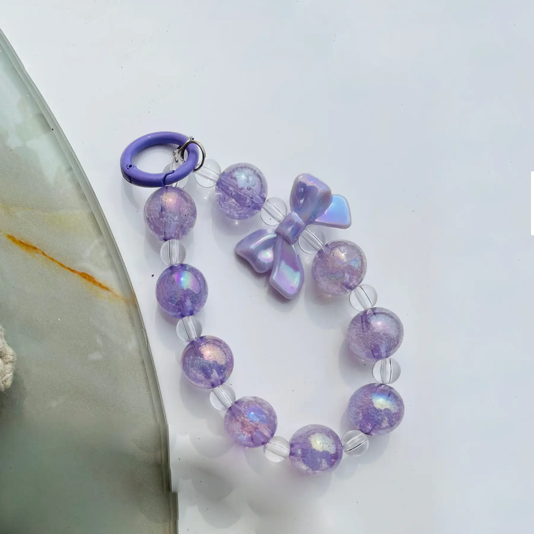 Peeperly Iridescent Lilac Bow Beaded Phone Charm