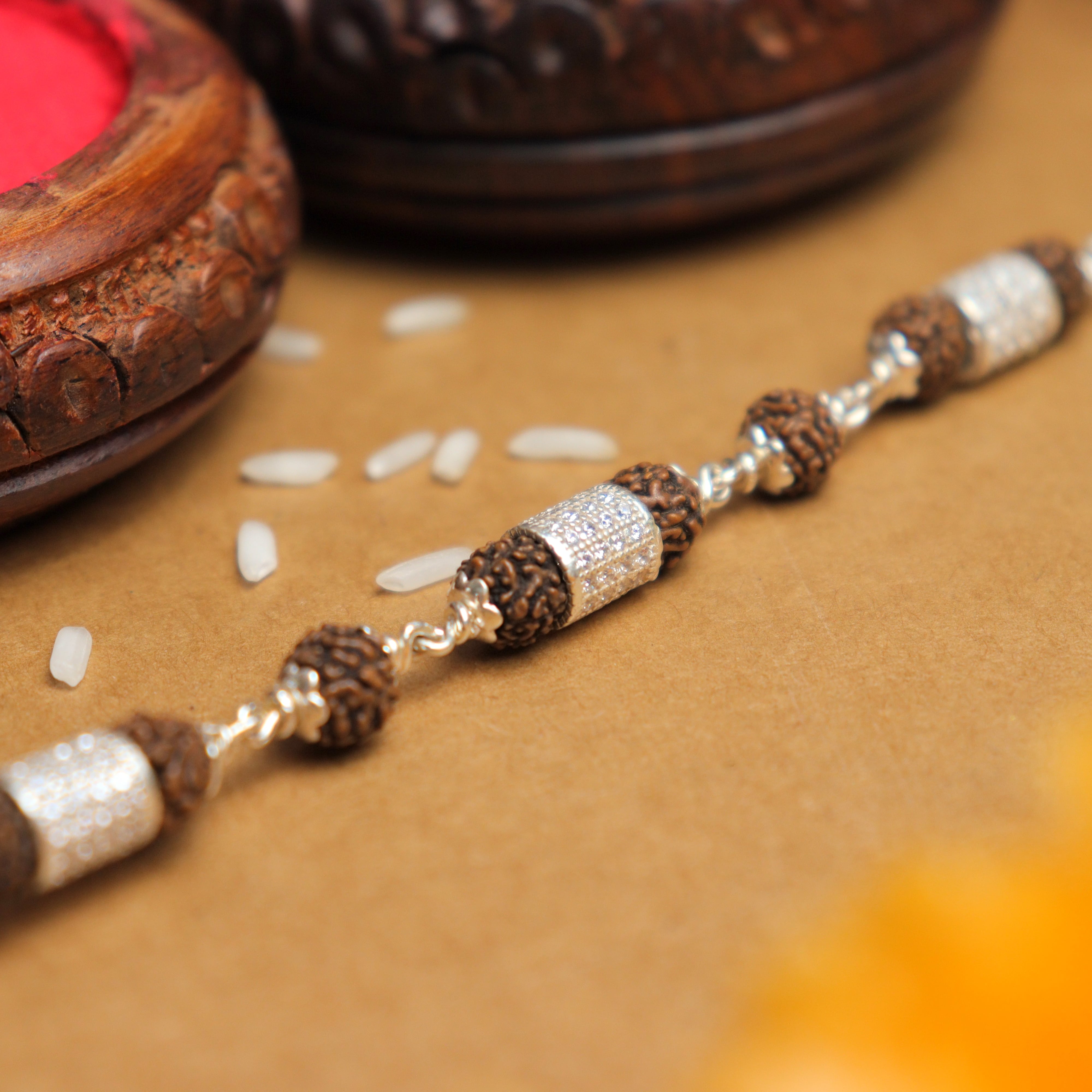 Prinjal Jewellers Silver Rakhi with Rudraksha and Three Diamond Cylinders