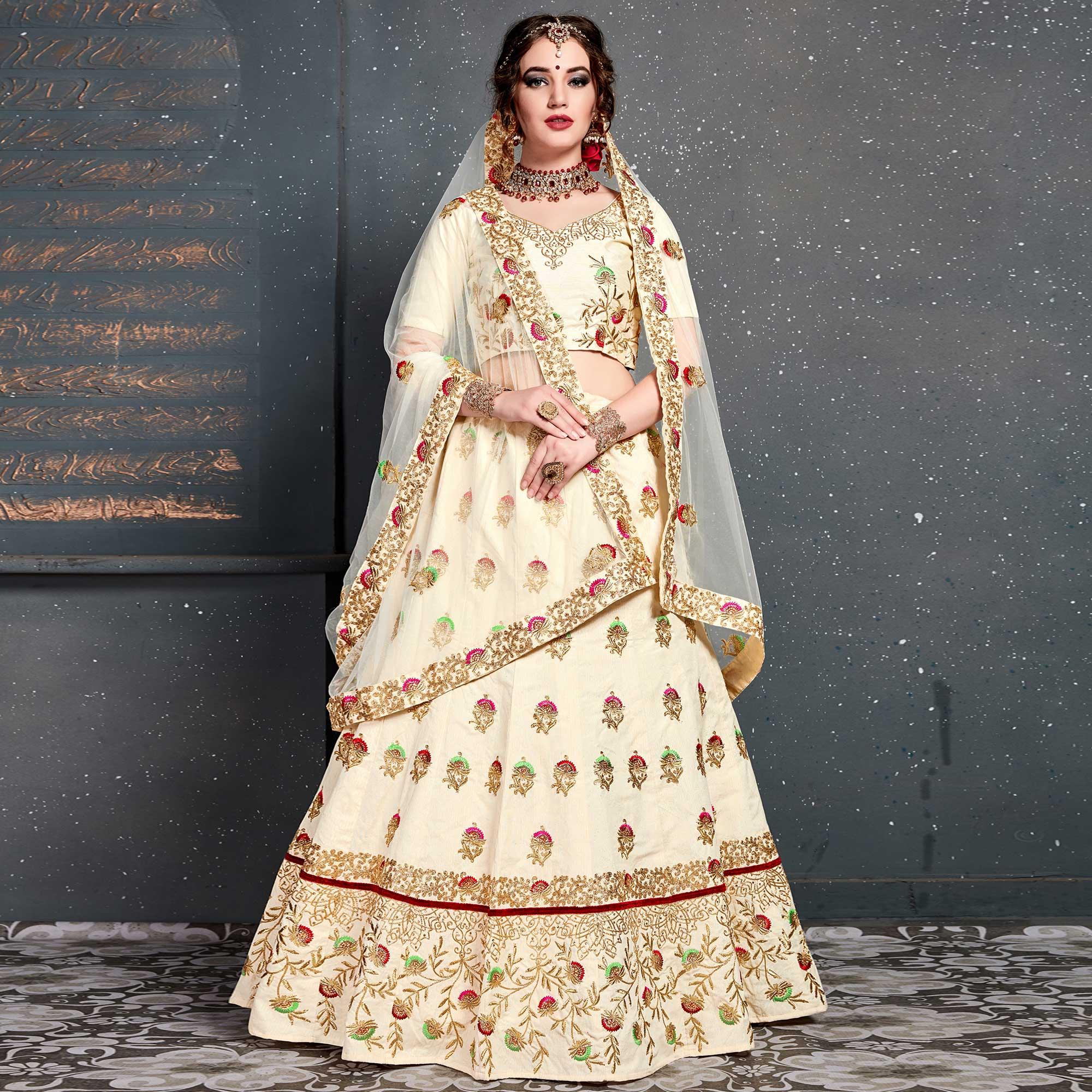 Peachmode Magnetic Cream Colored Wedding Wear Embroidered Silk Lehenga Choli