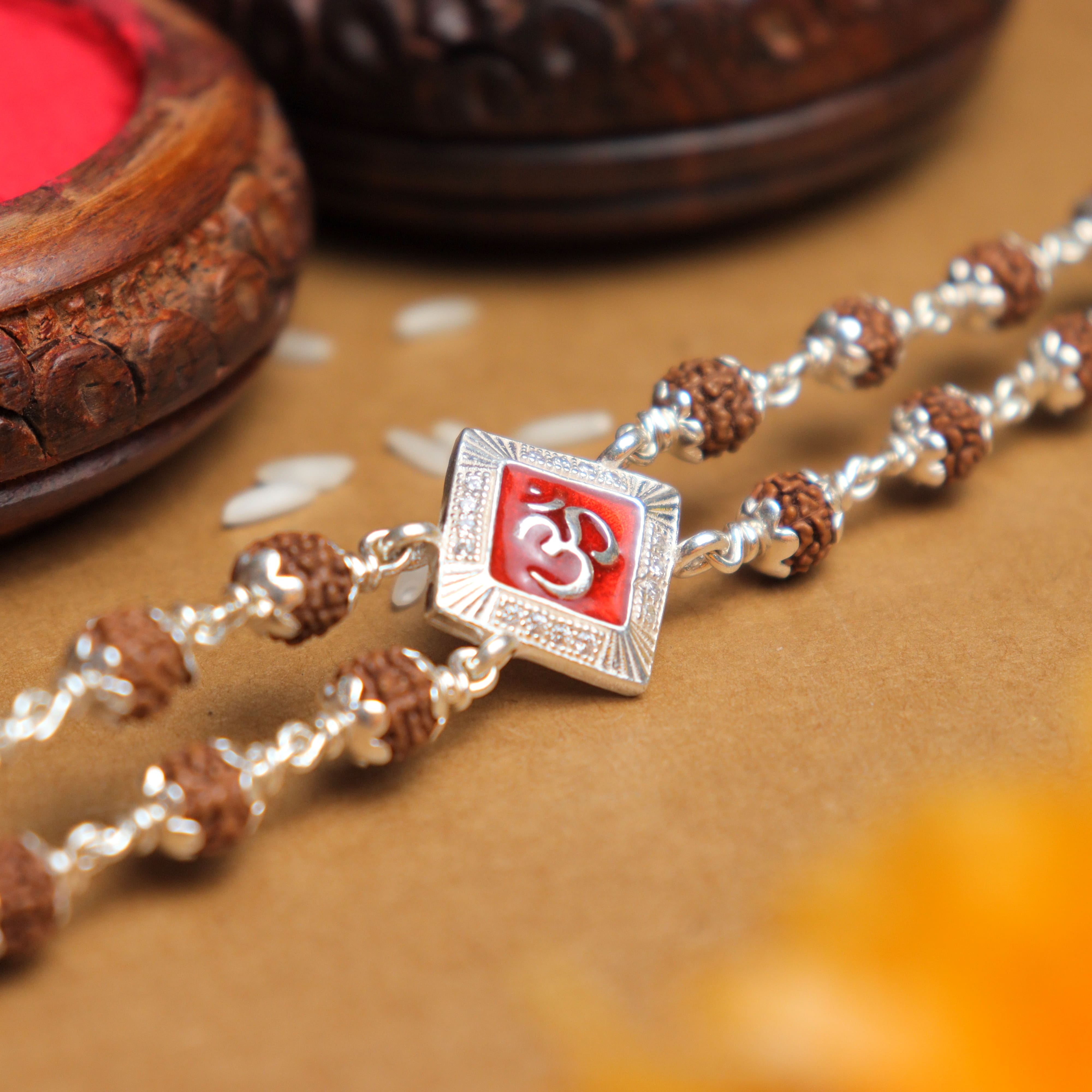 Prinjal Jewellers Silver Rakhi with Rudraksha and Om, Red-Colored Double Line Design