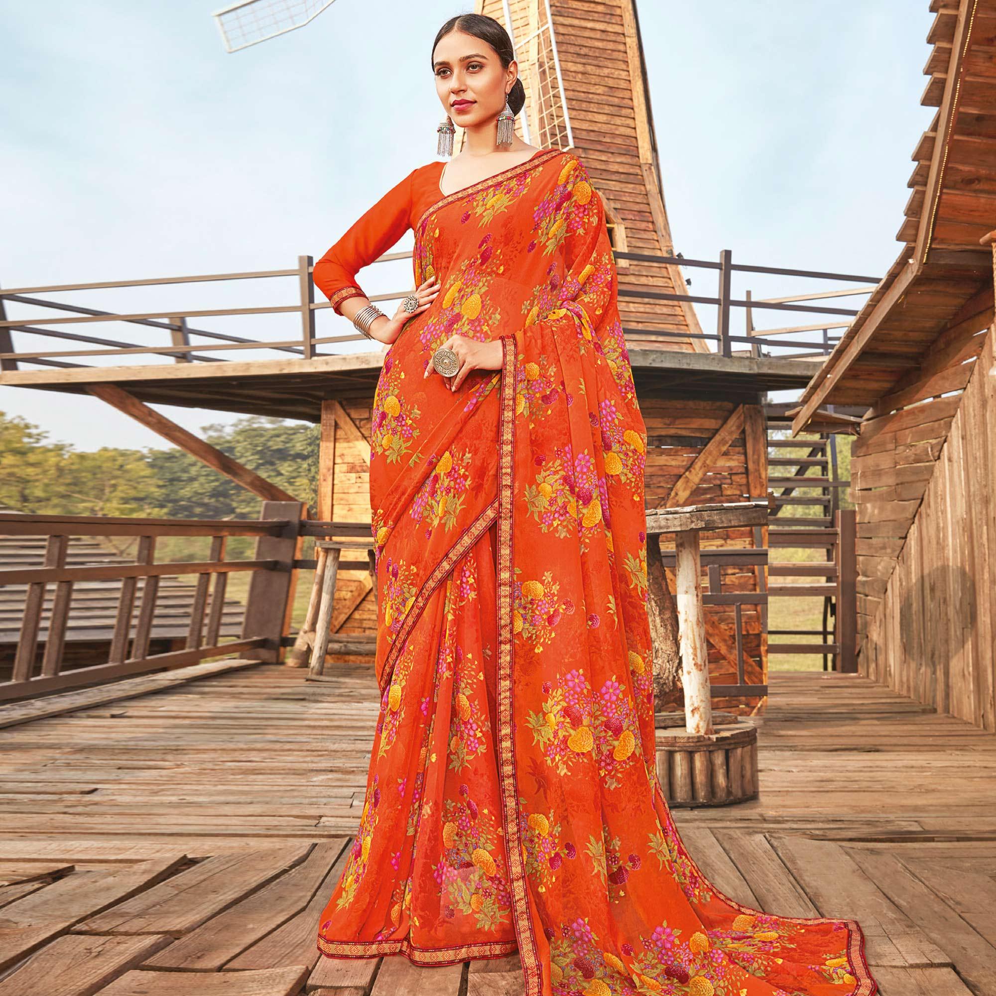 Peachmode Eye-catching Orange Coloured Partywear Pure Georgette Floral Printed Saree With Fancy Lace Border
