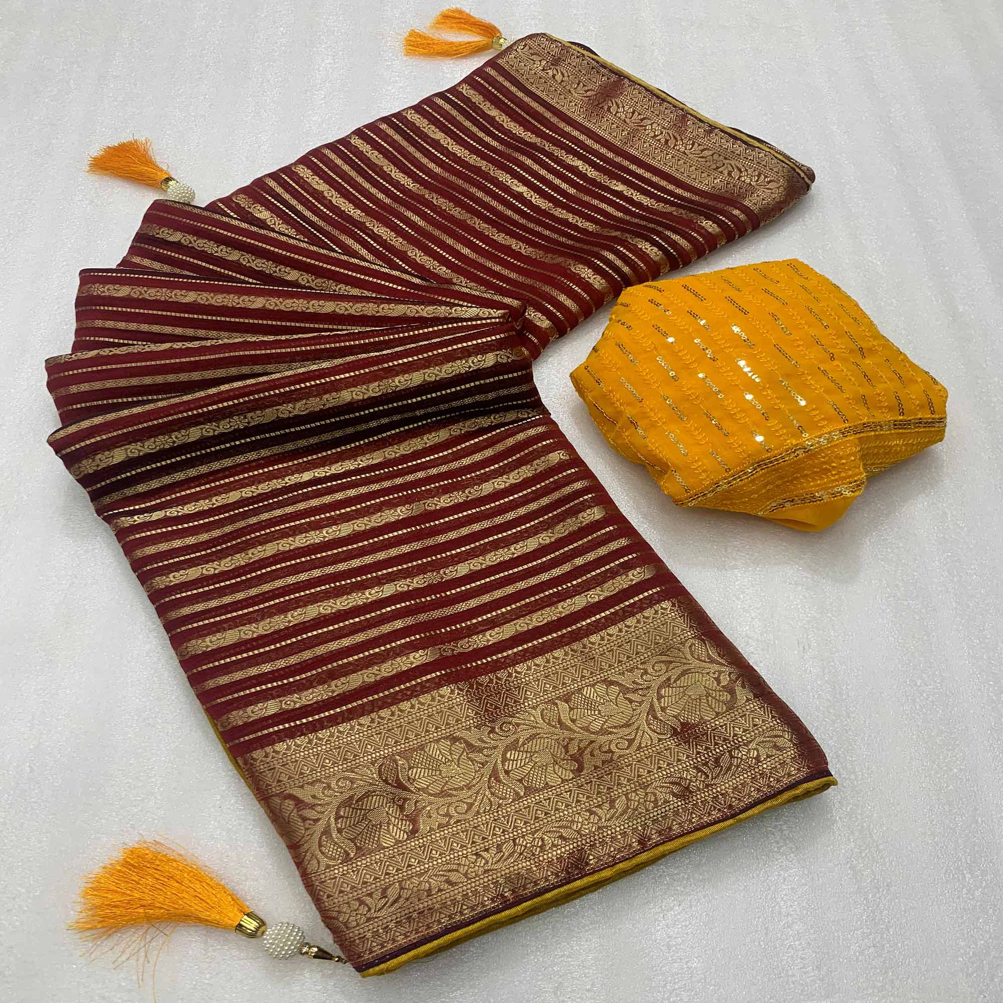 Peachmode Maroon Woven Georgette Saree With Tassels
