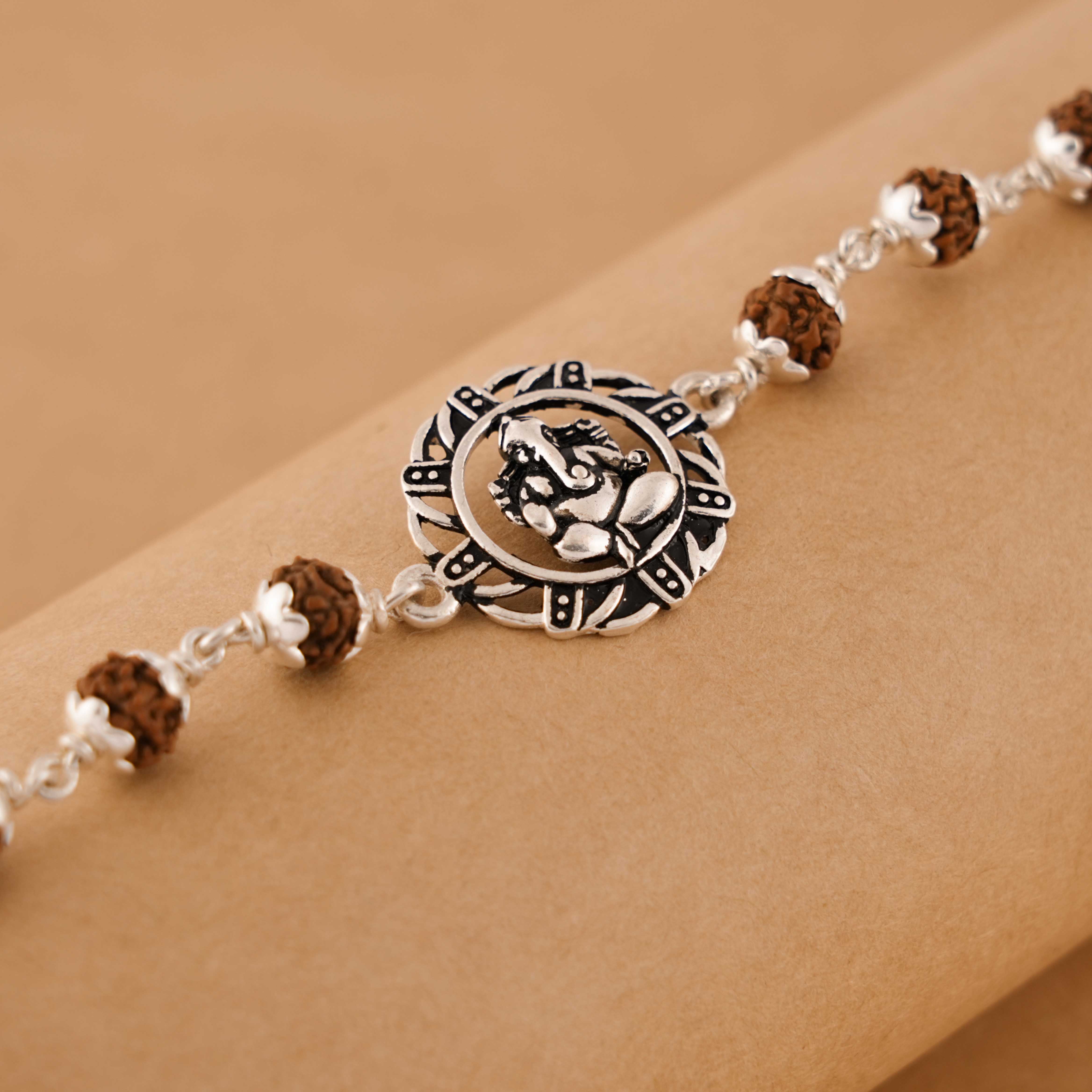 Prinjal Jewellers Rudraksha silver bracelet with Ganesh in a designer circular sphere single line
