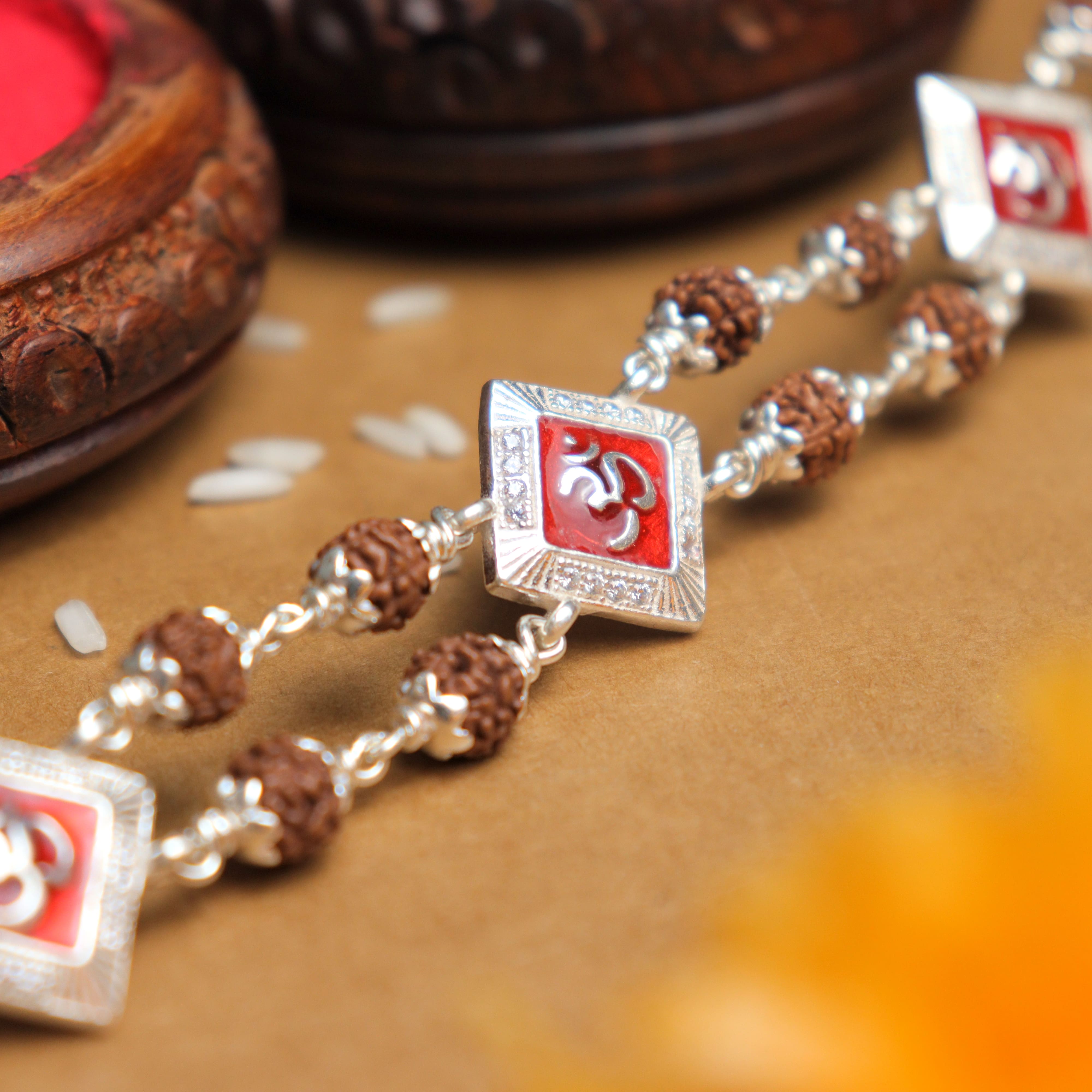 Prinjal Jewellers Silver Rakhi with Rudraksha, Om, and Three Rhombus Brooches, Double Line Design