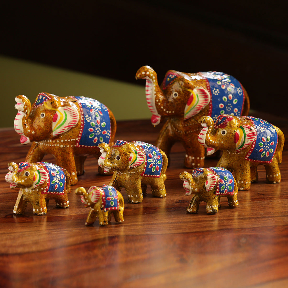 Hand carved handpainted – EXCLUSIVELANE 'Seven Tuskers In Brown' Hand Carved & Handpainted Showpiece In Resin (Set of 7)
