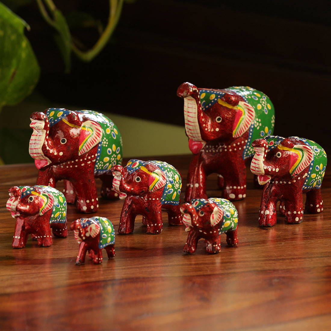 Hand carved handpainted – EXCLUSIVELANE 'Seven Tuskers In Maroon' Hand Carved & Handpainted Showpiece In Resin (Set of 7)