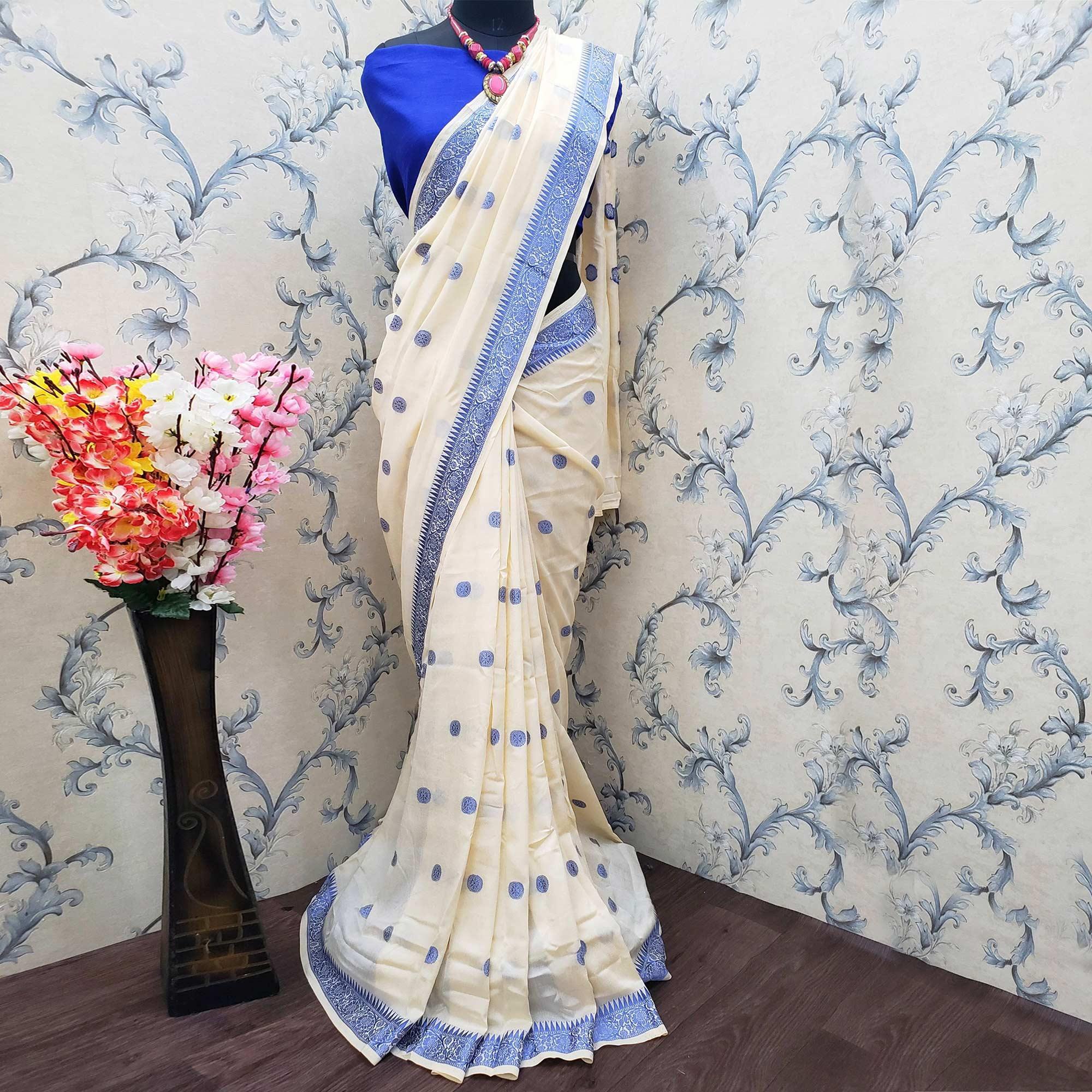 Peachmode Impressive Cream Colored Festive Wear Woven Vichitra Silk Saree