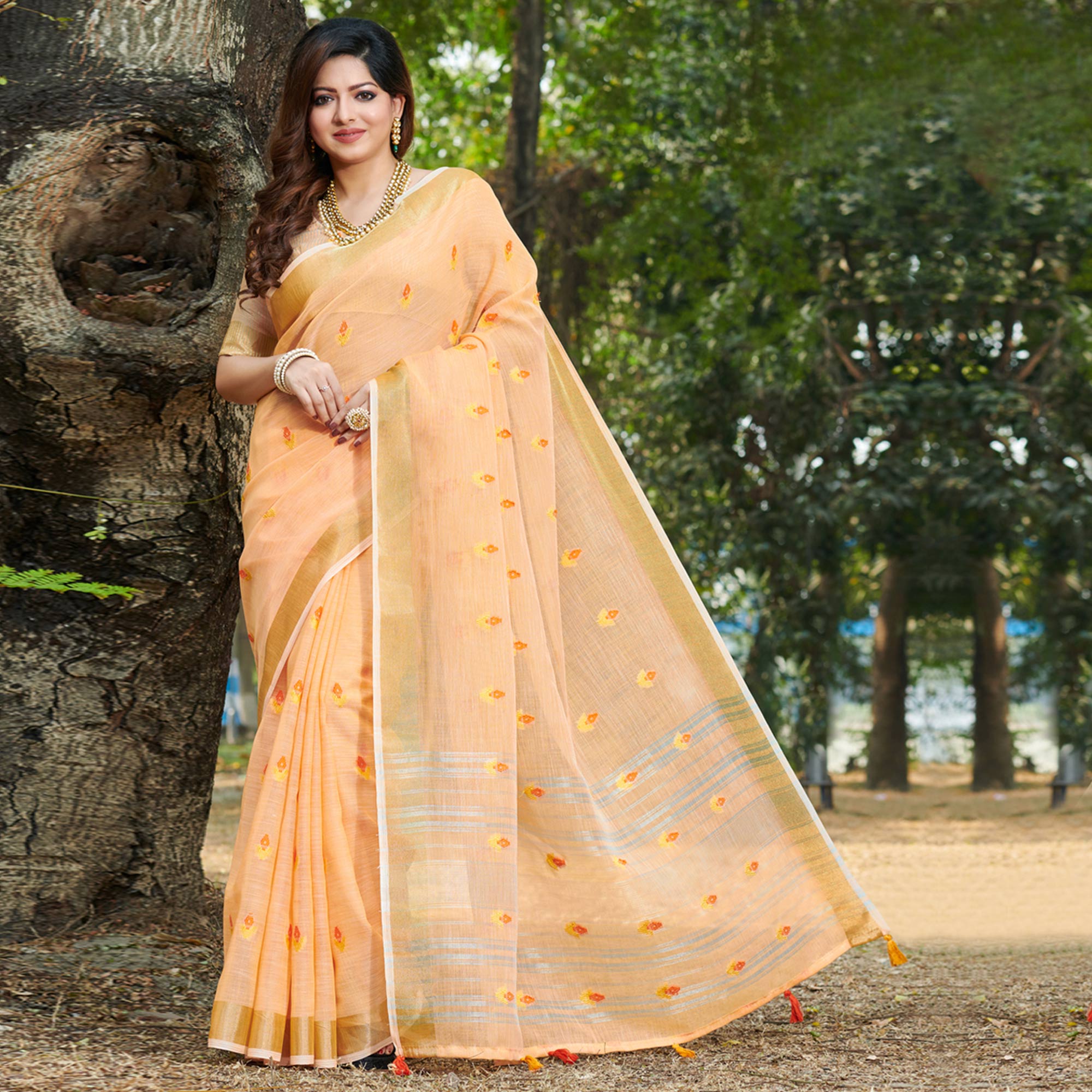Peachmode Light Orange Embroidered Linen Saree With Tassels