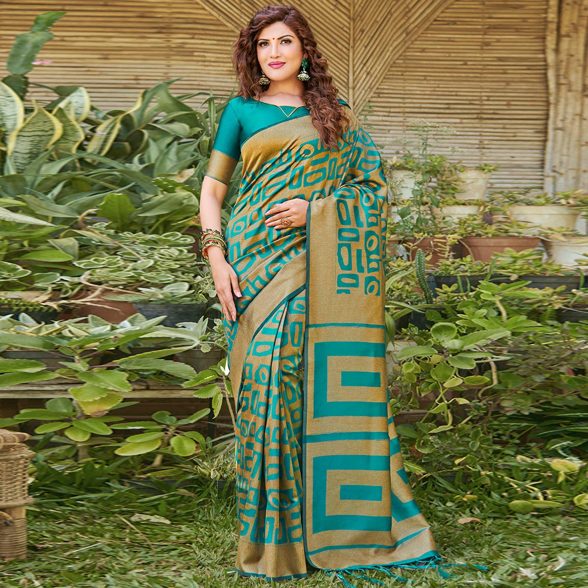 Peachmode Impressive Teal Blue Colored Festive Wear Floral Woven Silk Blend Saree With Tassels