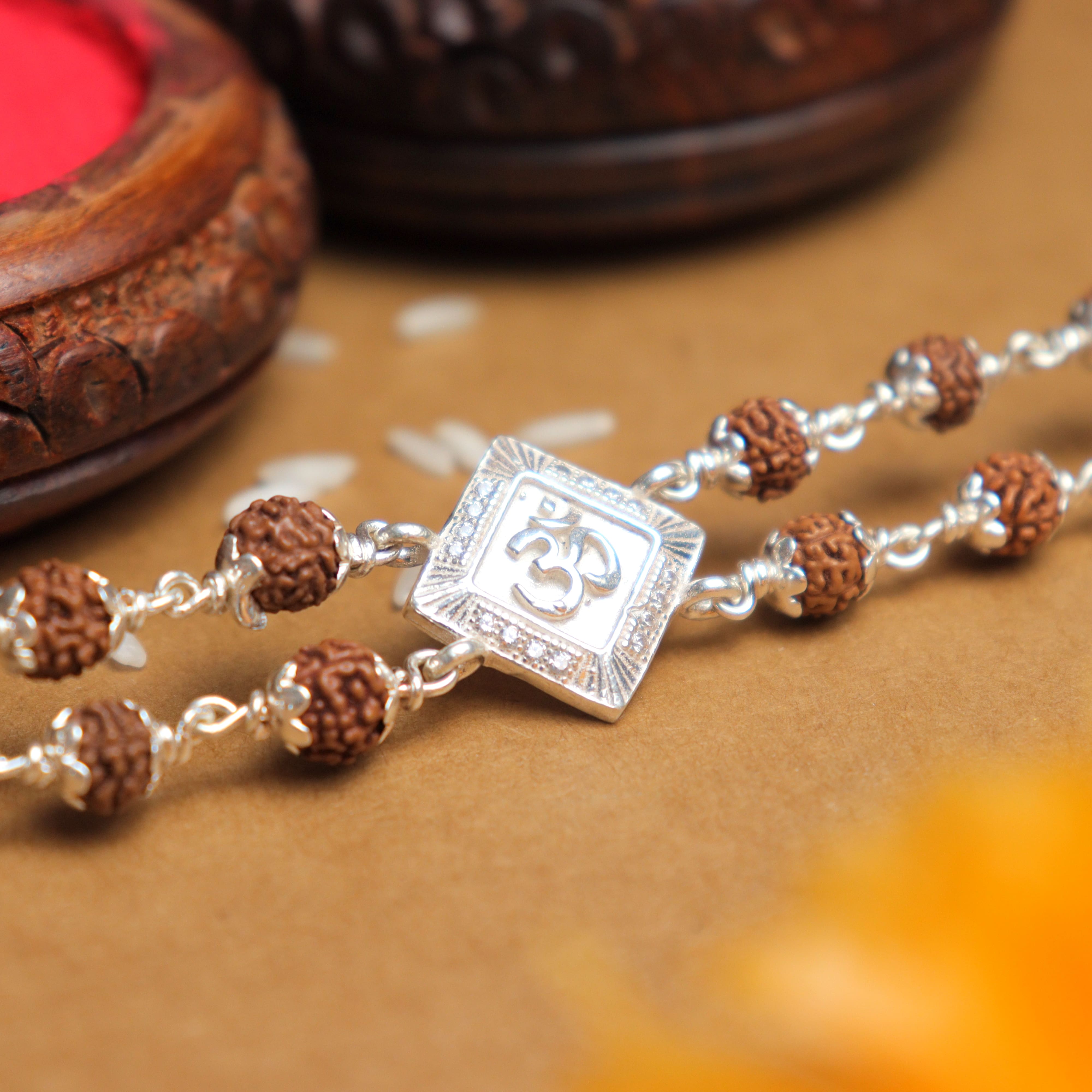 Prinjal Jewellers Silver Rakhi with Rudraksha, Om, and Rhombus Double Line Design