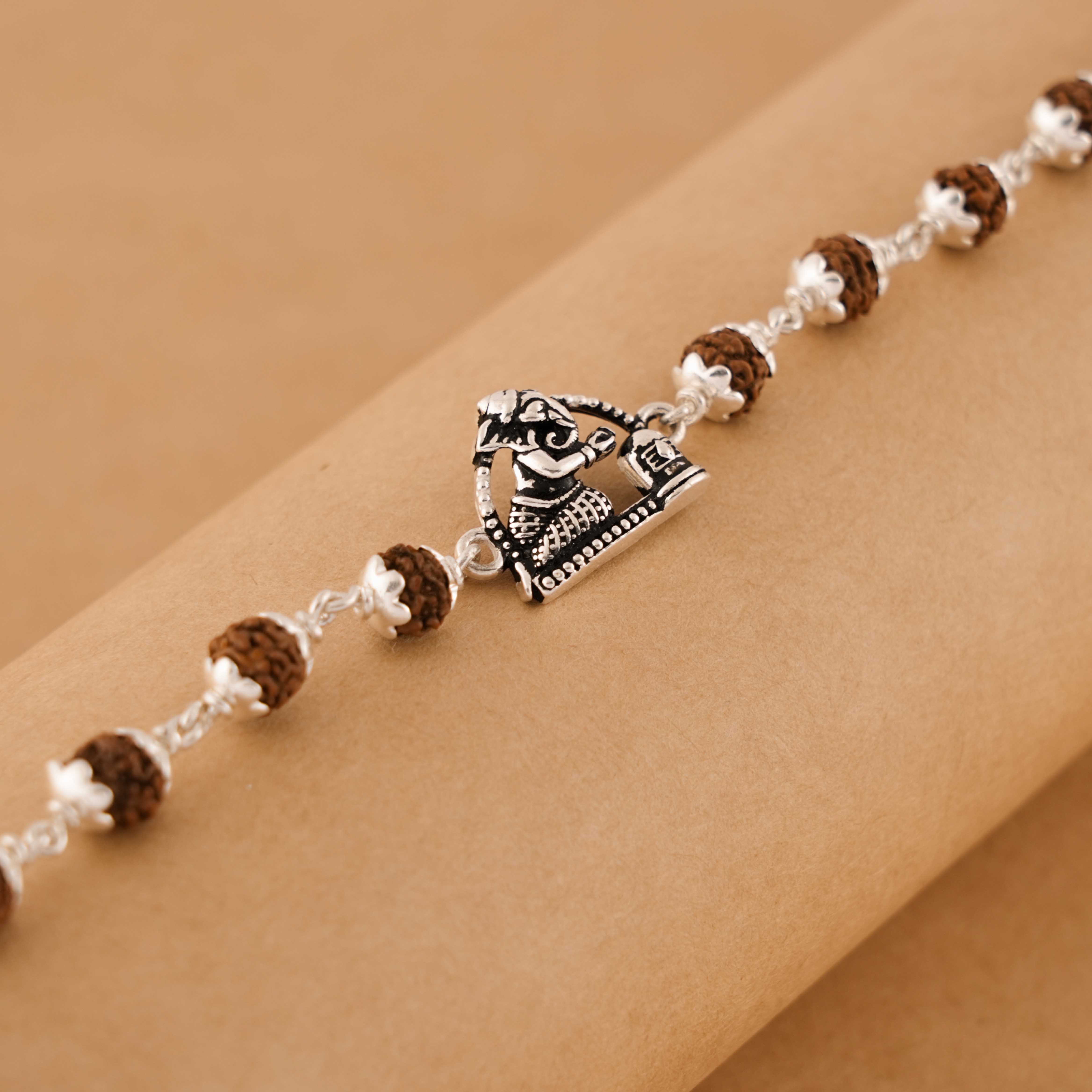Prinjal Jewellers Rudraksha silver bracelet with folded-hand Ganesh
