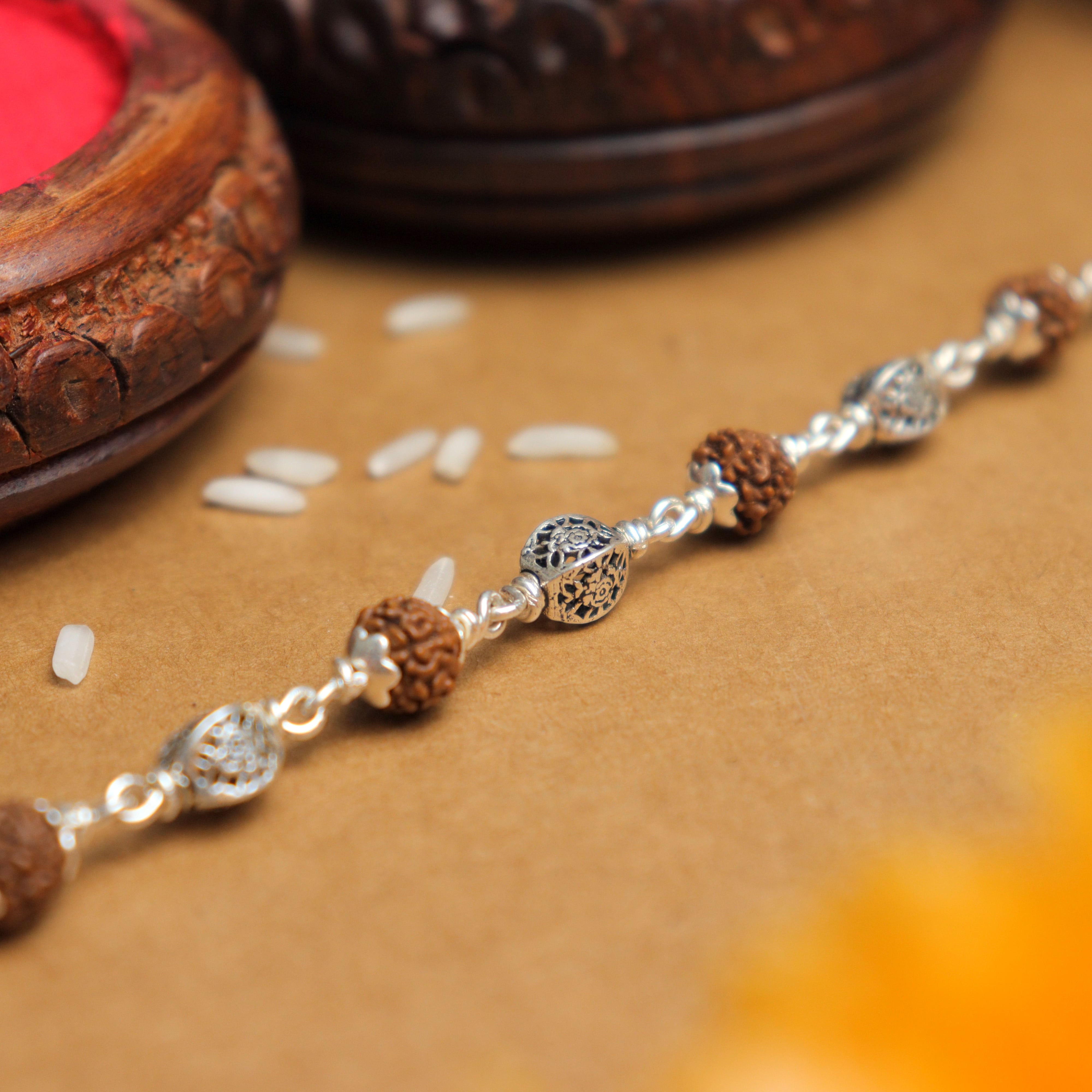 Prinjal Jewellers Silver Rakhi with Rudraksha and Hollow Circular Beads