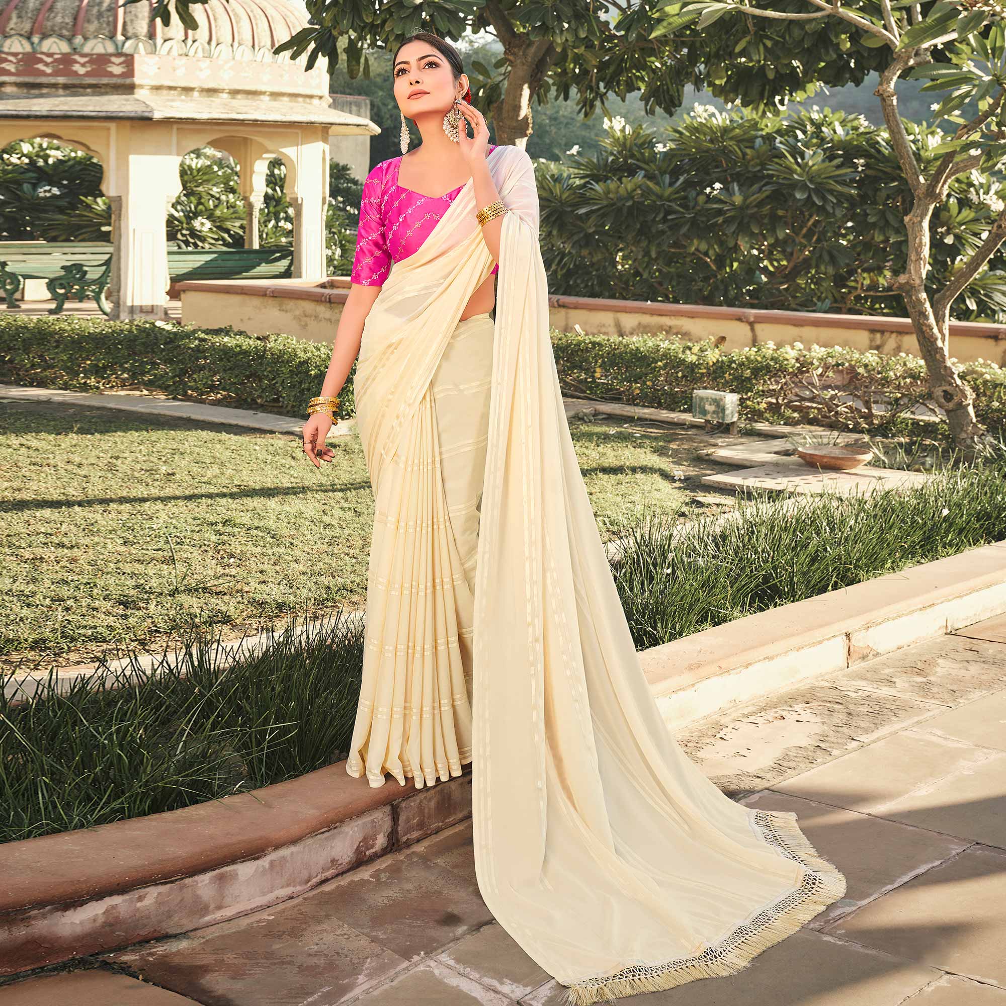 Peachmode Cream Printed Georgette Saree With Tassels