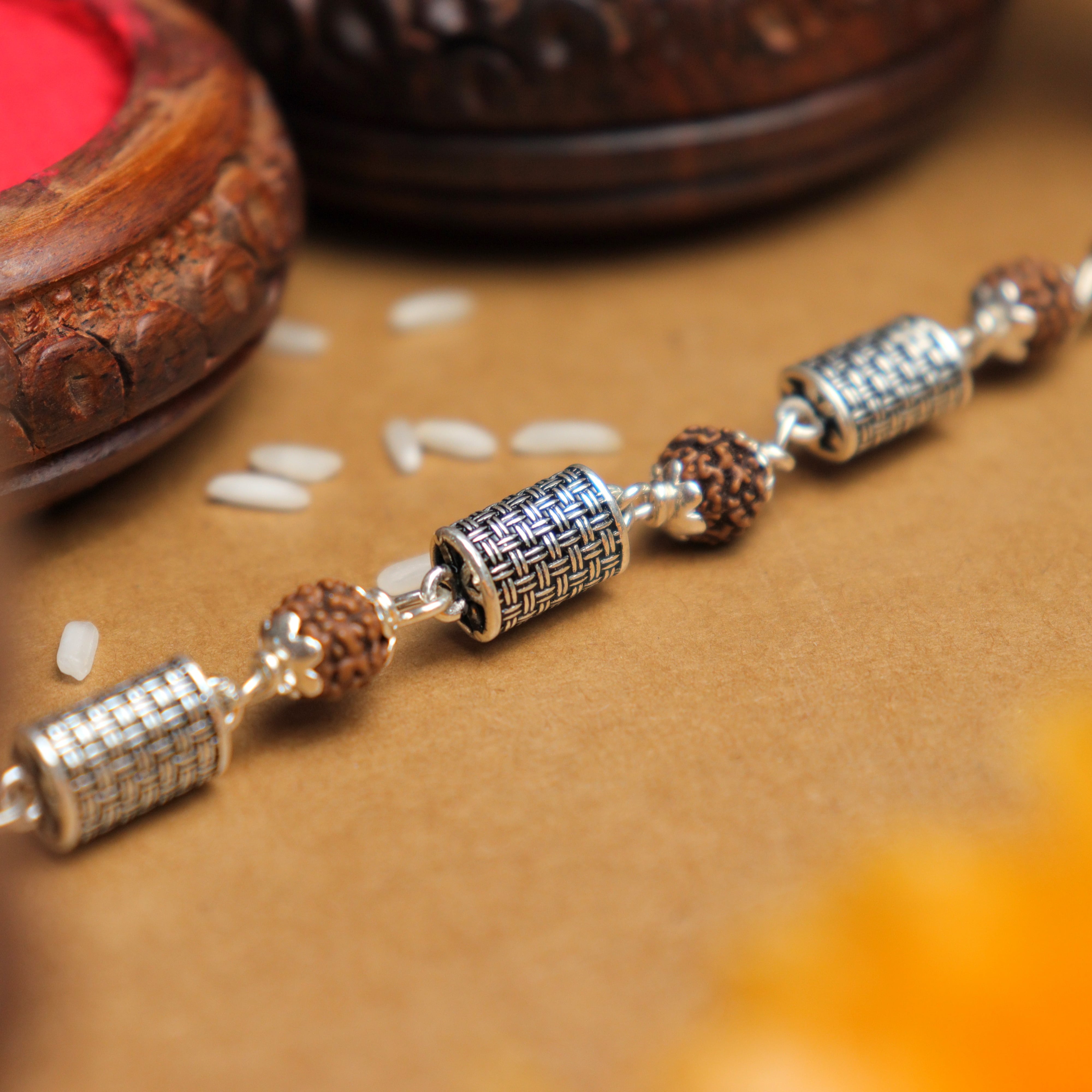 Prinjal Jewellers Silver Rakhi with Rudraksha and Hollow Cylindrical Beads