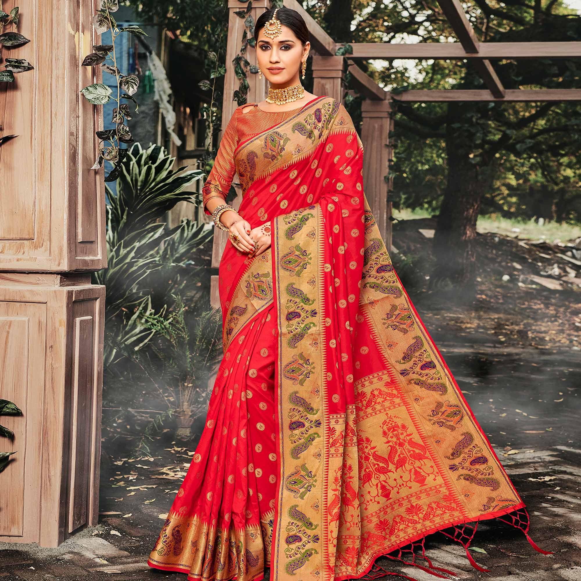 Peachmode Intricate Coral Red Colored Festive Wear Woven Banarasi Silk Saree With Tassels