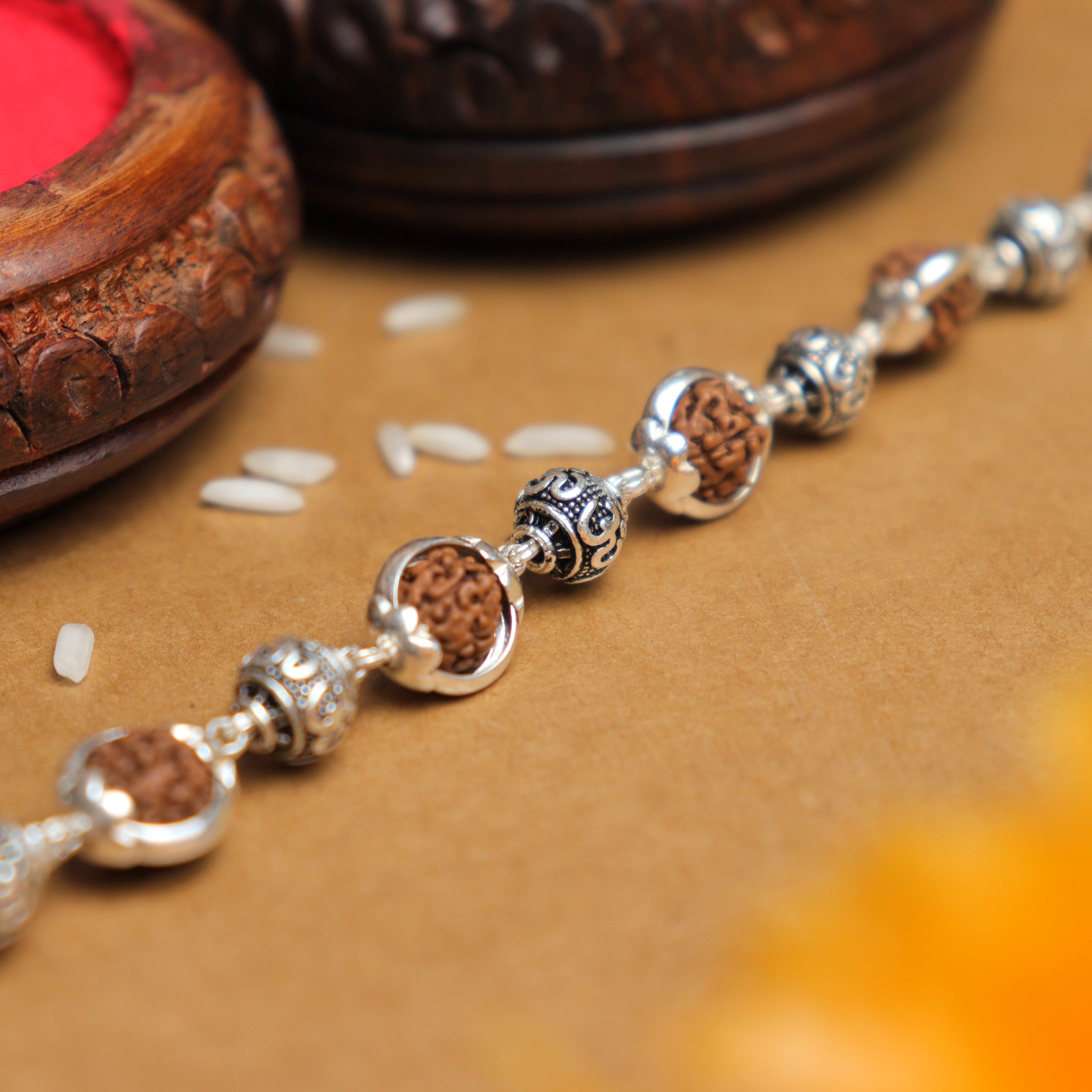 Prinjal Jewellers Silver Rakhi with Om Beads Capping and Rudraksha Bracelet