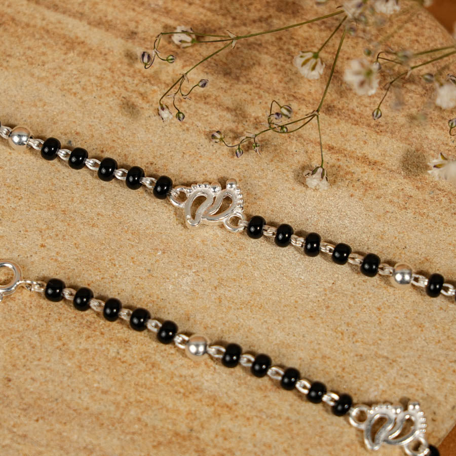 Prinjal Jewellers black beads with silver baby feet nazariya for kids